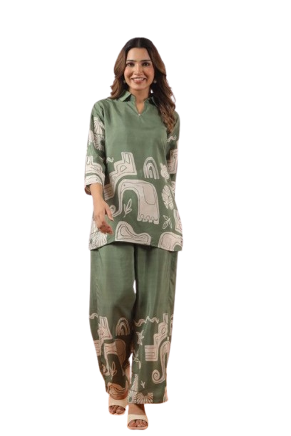 Woman wearing green patterned tunic and matching pants outfit.
